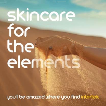 A woman's hand with sand falling from it against the backdrop of a dune